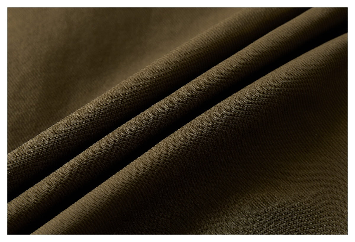 Close-up showing the textured olive-brown fabric folded into diagonal ridges.