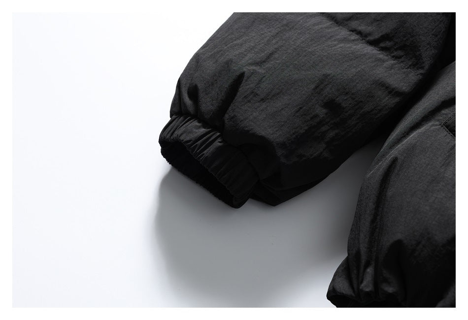 Close-up of the black jacket's gathered elastic sleeve cuff.