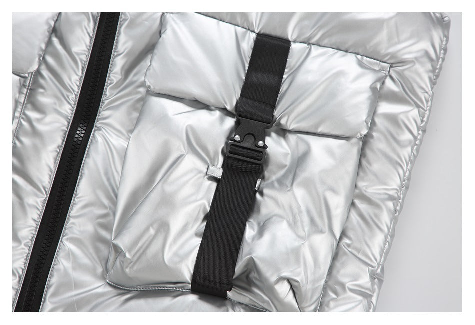 Close-up of a silver flap pocket with a black adjustable strap and buckle beside the front zipper.