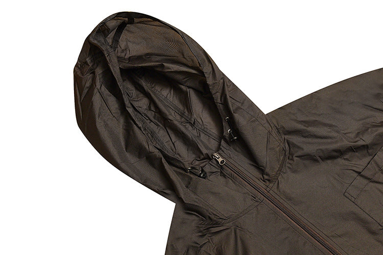 Close-up of a dark jacket hood with drawcords and a front zipper on a white background.