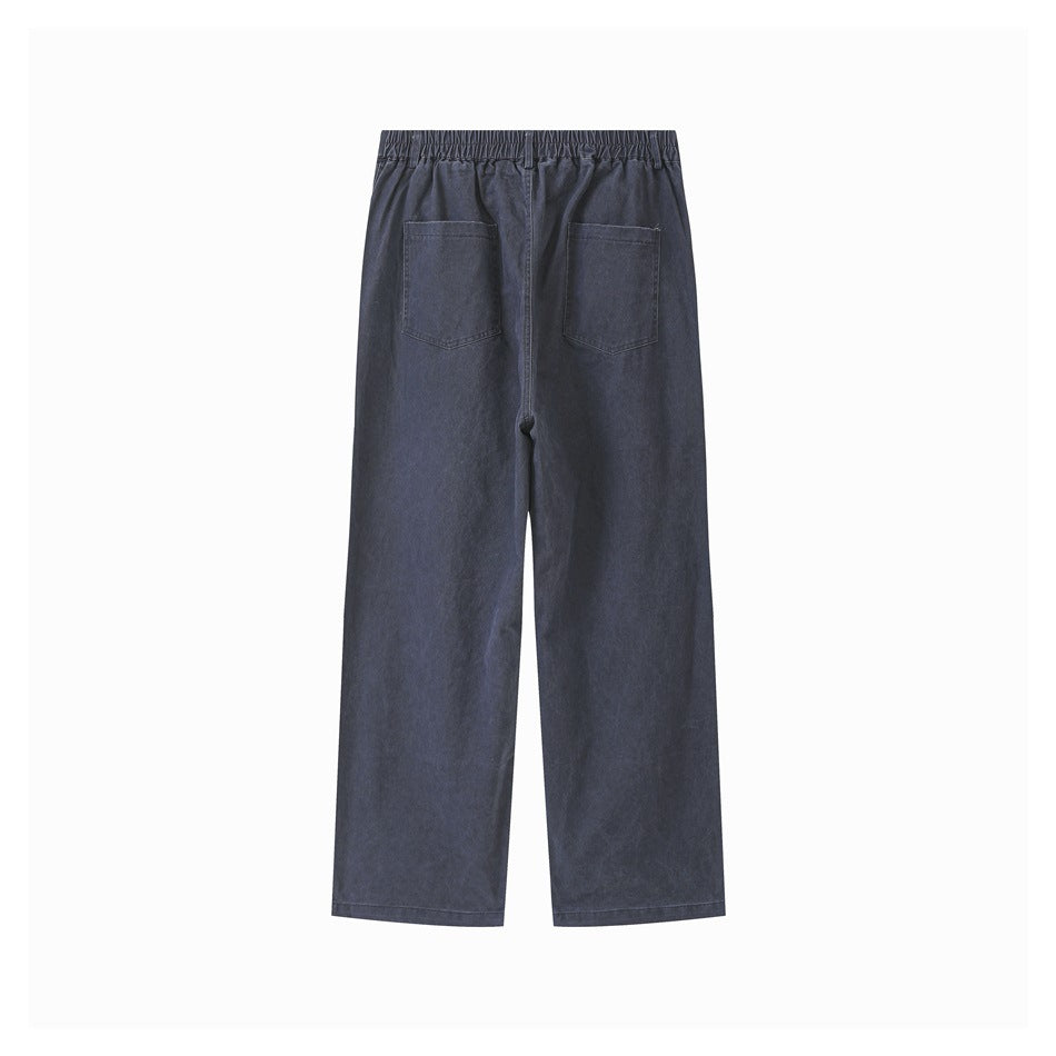 Back view of dark navy wide-leg trousers with a gathered waistband and two patch pockets.
