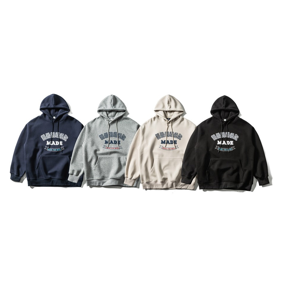 Four front-facing pullover hoodies with kangaroo pockets and English chest graphics in navy, gray, cream, and black.