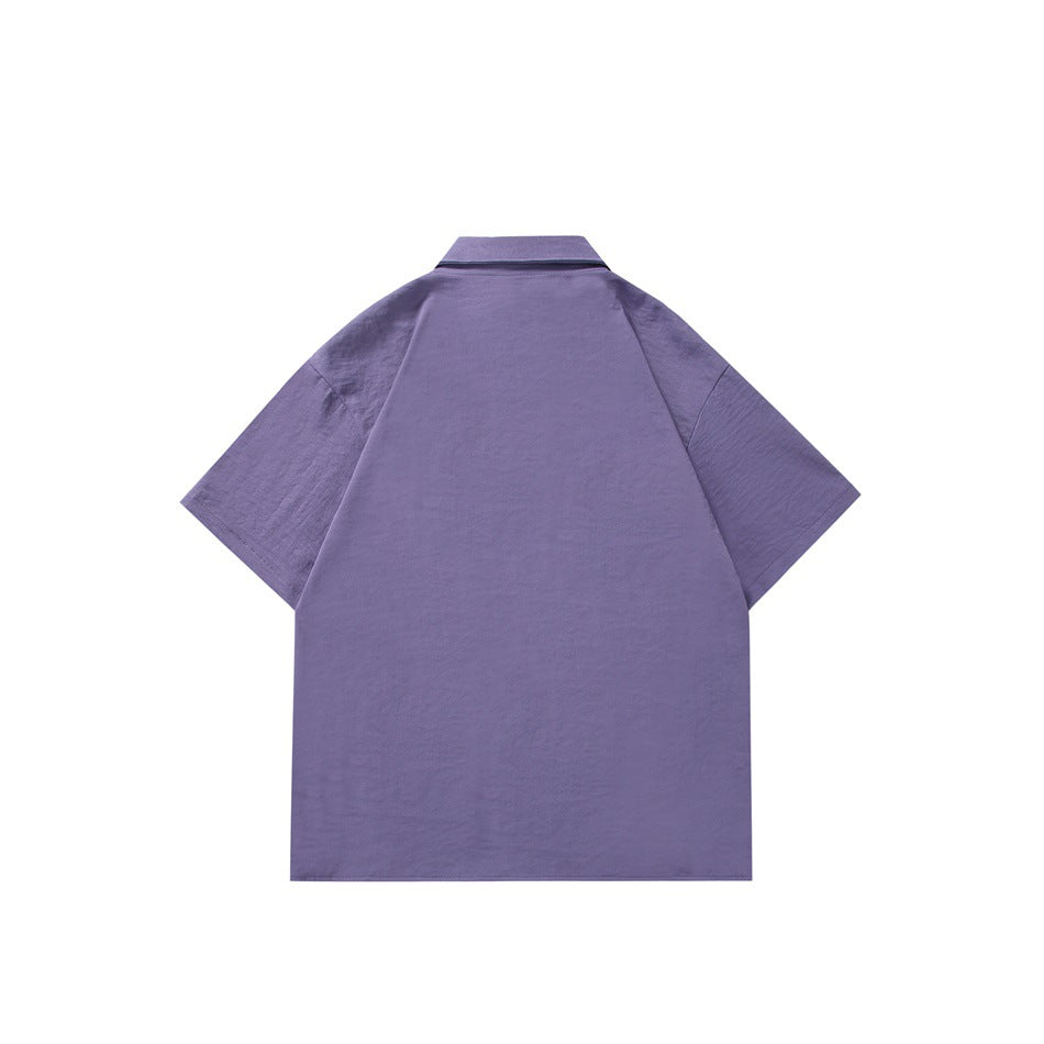 Back view of a purple short-sleeve collared shirt with a plain body and raglan-style sleeves.