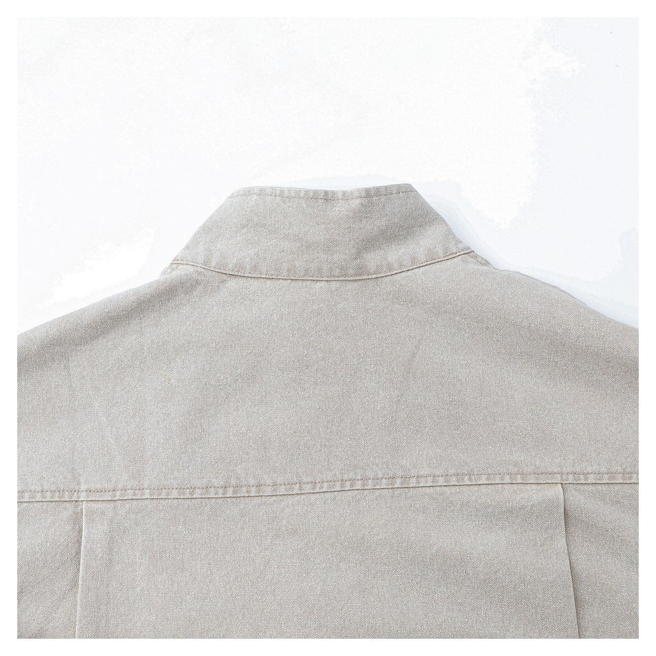 Close-up of the back collar and yoke seam on a light beige jacket.