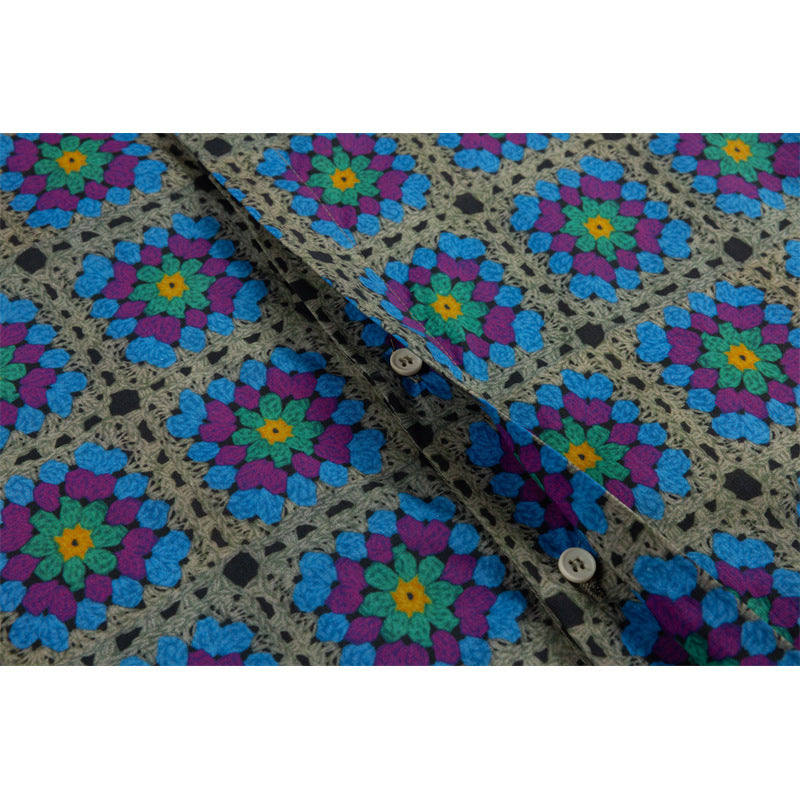 Close-up of the gray shirt's button placket with two light buttons and a bright multicolor floral pattern.