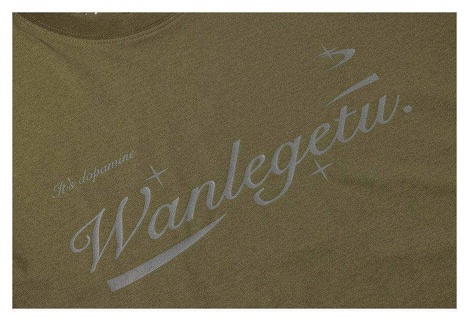 Close-up of a gray script graphic printed across the front of an olive-green shirt.