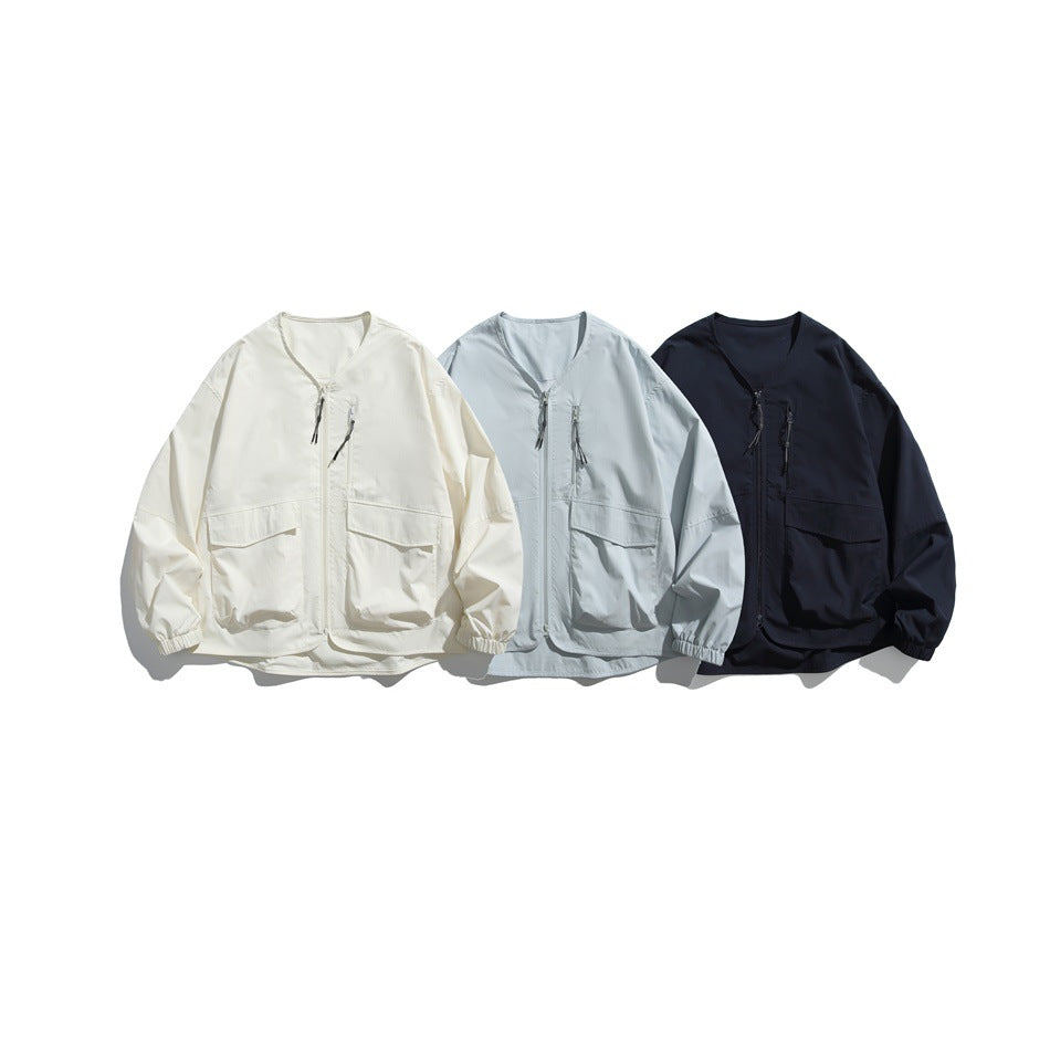 Three front-view jackets with V-necks, zippers, flap pockets, and elastic cuffs in ivory, pale blue, and navy.