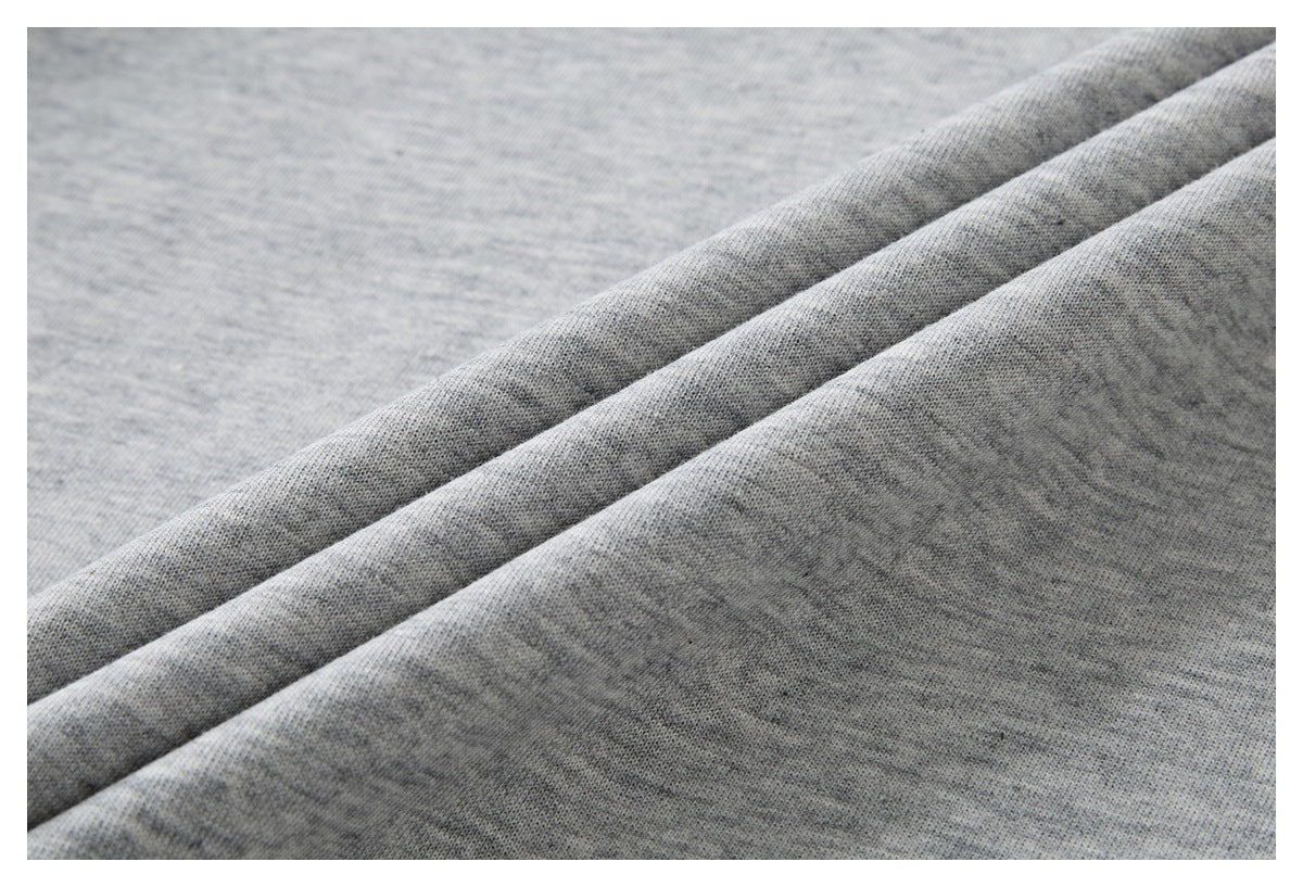 Close-up of the heathered gray garment fabric, draped in soft folds.