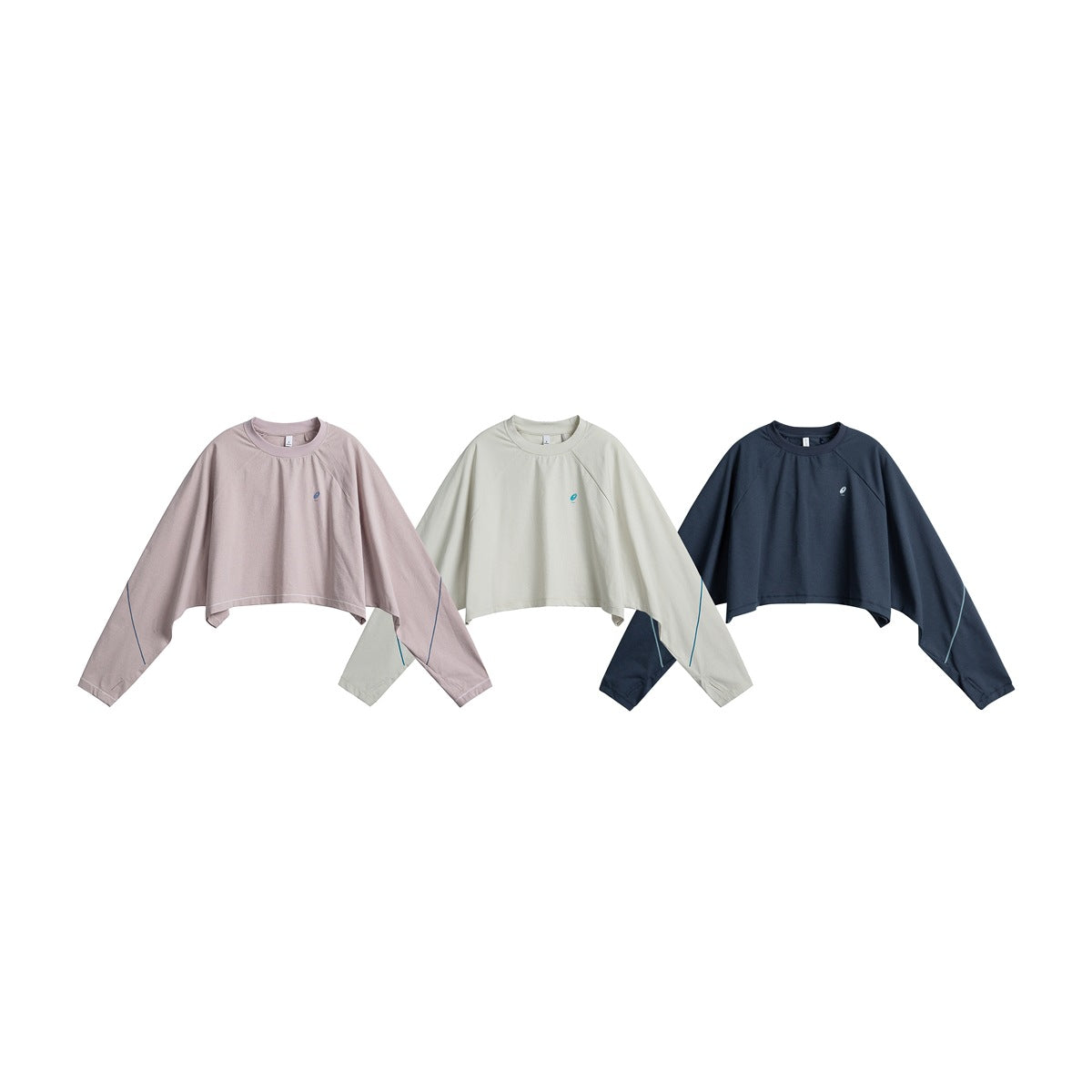 Three cropped long-sleeve tops displayed flat in dusty pink, pale sage, and navy.