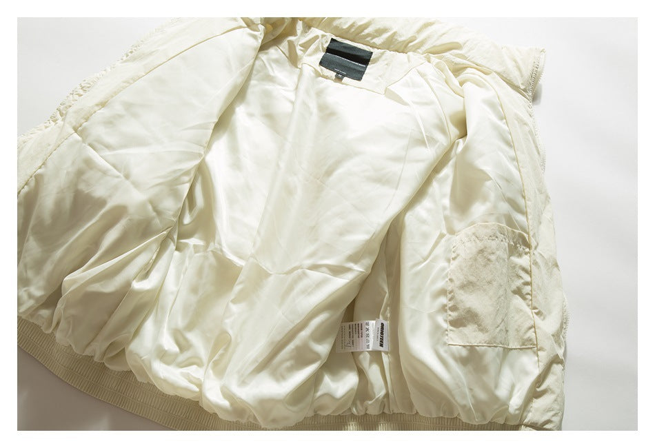Ivory jacket opened flat, showing its smooth lining, inner pocket, ribbed hem and labels.