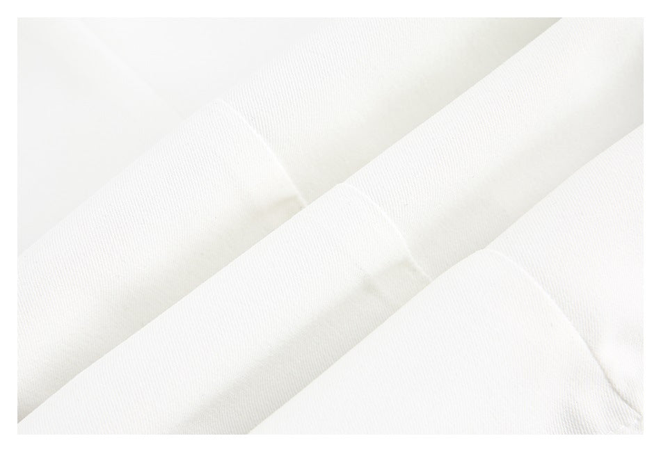 Close-up of softly folded white fabric showing its surface texture.