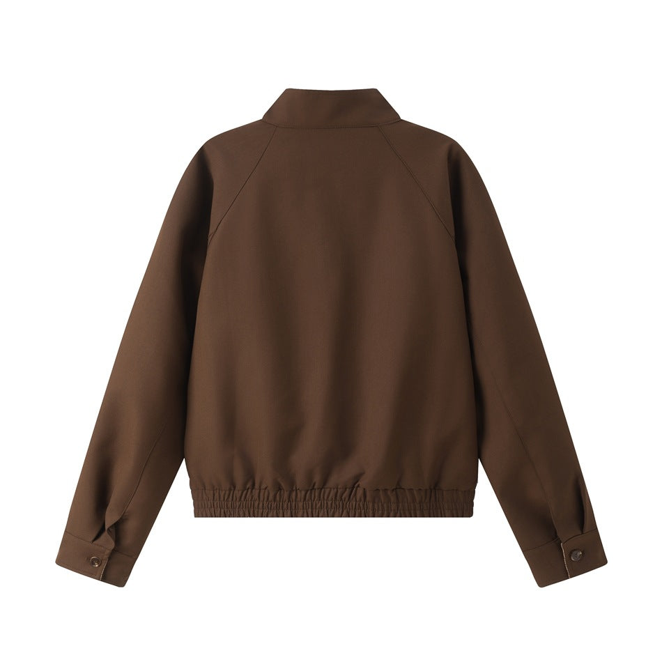 Back view of a brown jacket with raglan sleeves, a stand collar, buttoned cuffs, and a gathered hem.