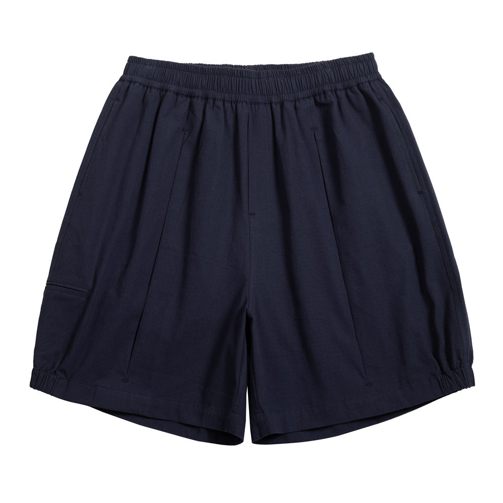 Navy elastic-waist pleated knee-length shorts with a side thigh pocket and elasticized hems, flat lay front view