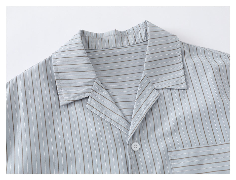 Close-up of the shirt's pinstriped camp collar, button placket, and upper chest pocket.