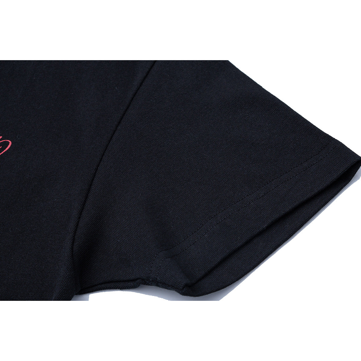 Close-up of the sleeve and stitched hem on a black T-shirt.