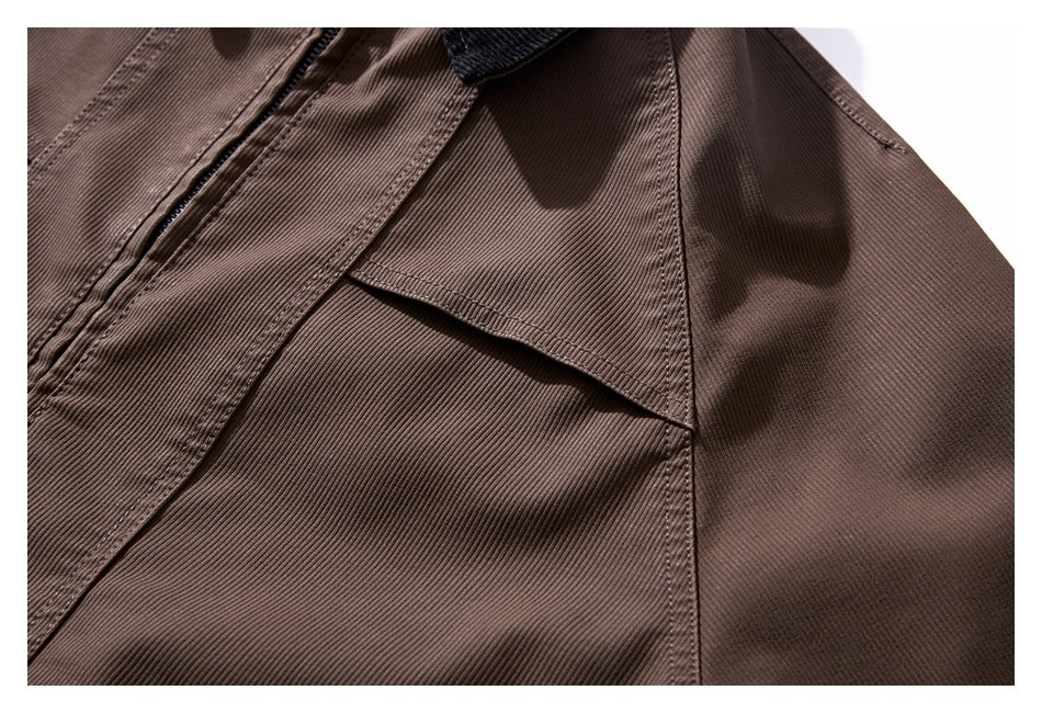 Close-up of a brown ribbed jacket with a stitched flap pocket and panel seams.