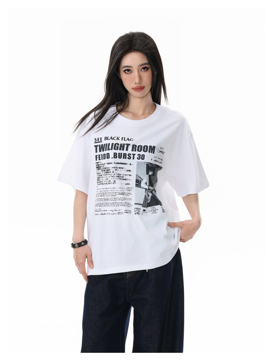 Model wearing a white oversized T-shirt with a large black concert-poster-style graphic on the front.