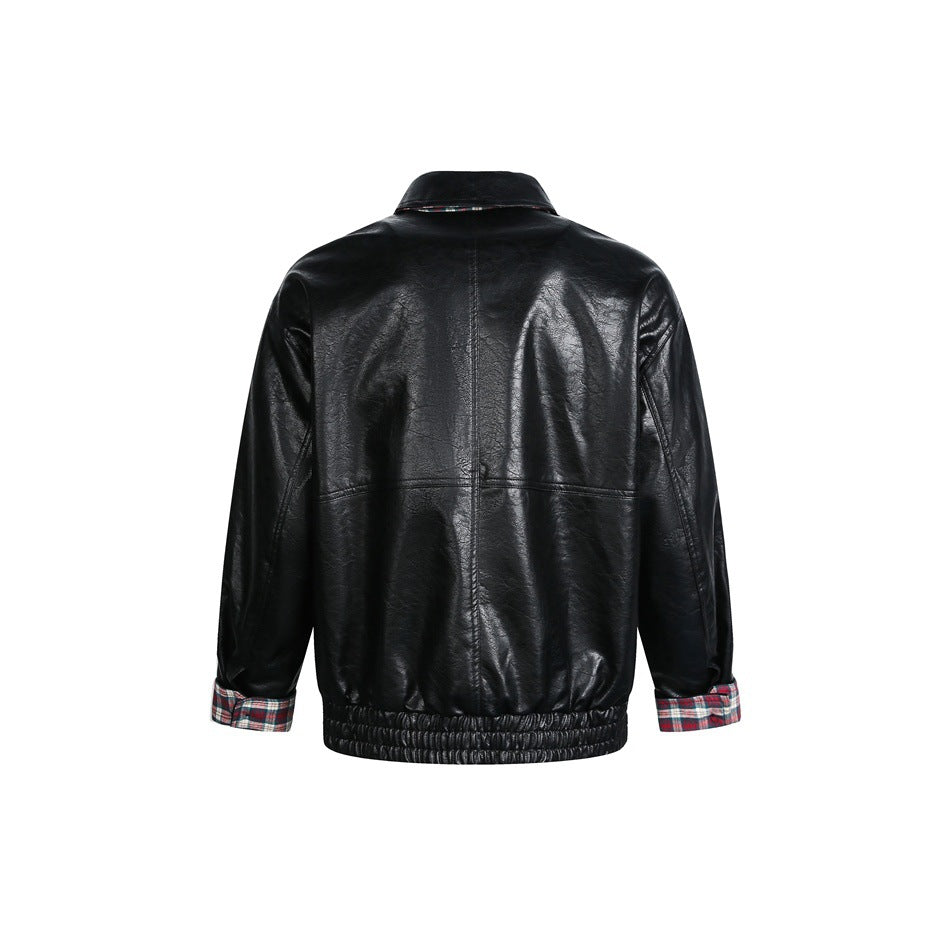 Back view of a black leather-look jacket with a center seam, gathered hem, and plaid turnback cuffs.