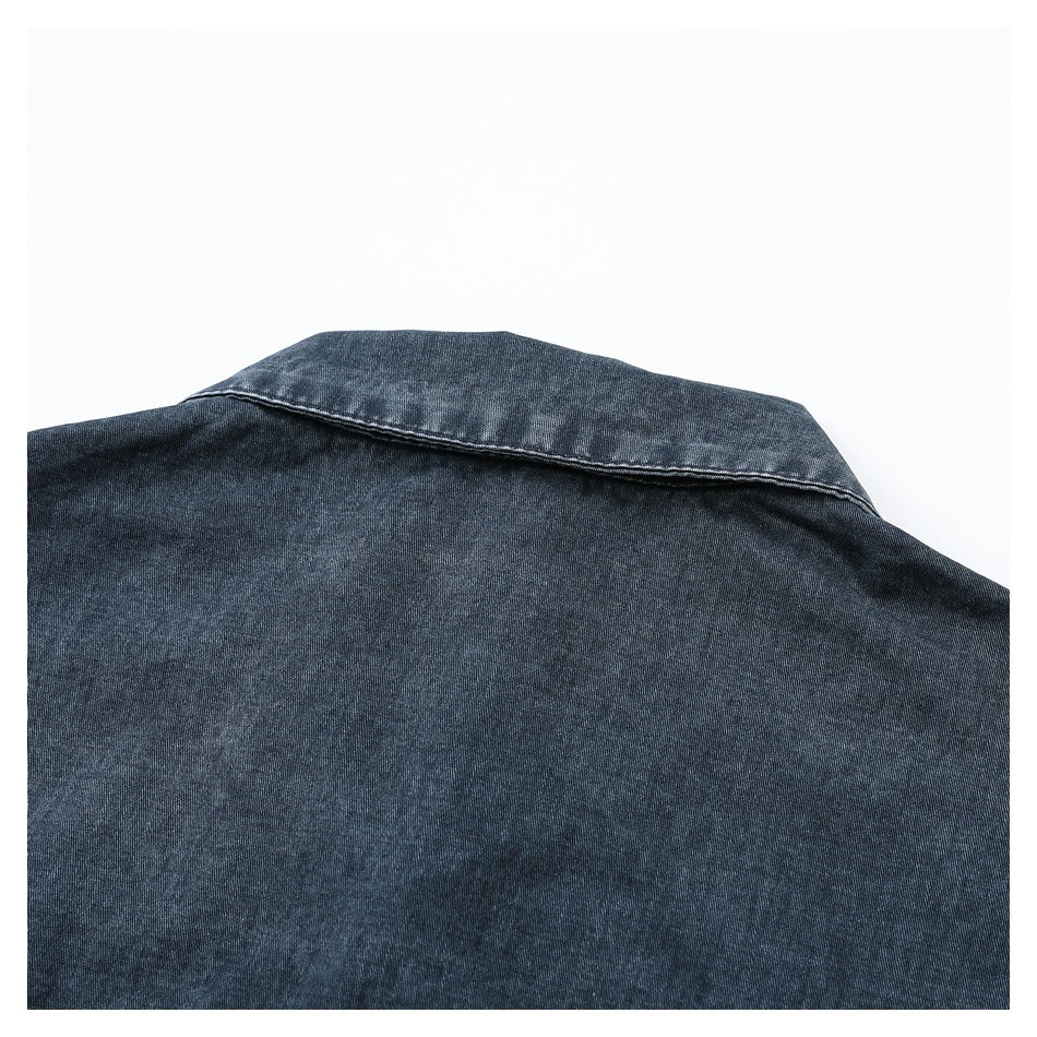 Close-up of the back collar and upper panel of a dark blue denim garment.