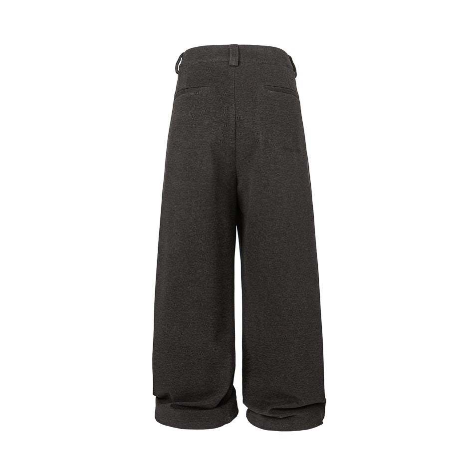 Back view of charcoal wide-leg trousers with two welt pockets and a center seam.
