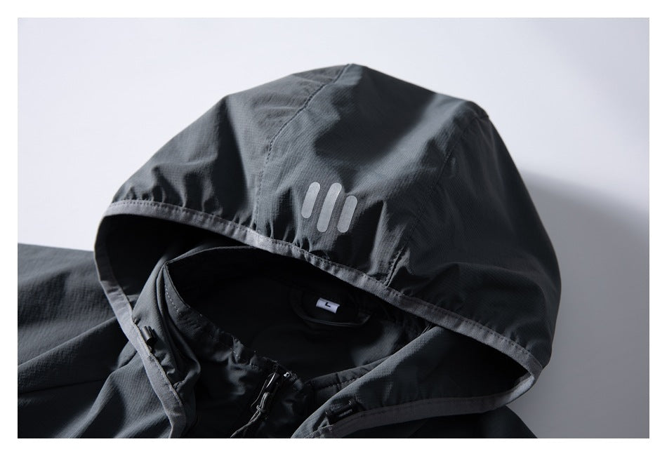 Close-up of a dark gray jacket hood with a three-bar mark, visible zipper, and size L label.