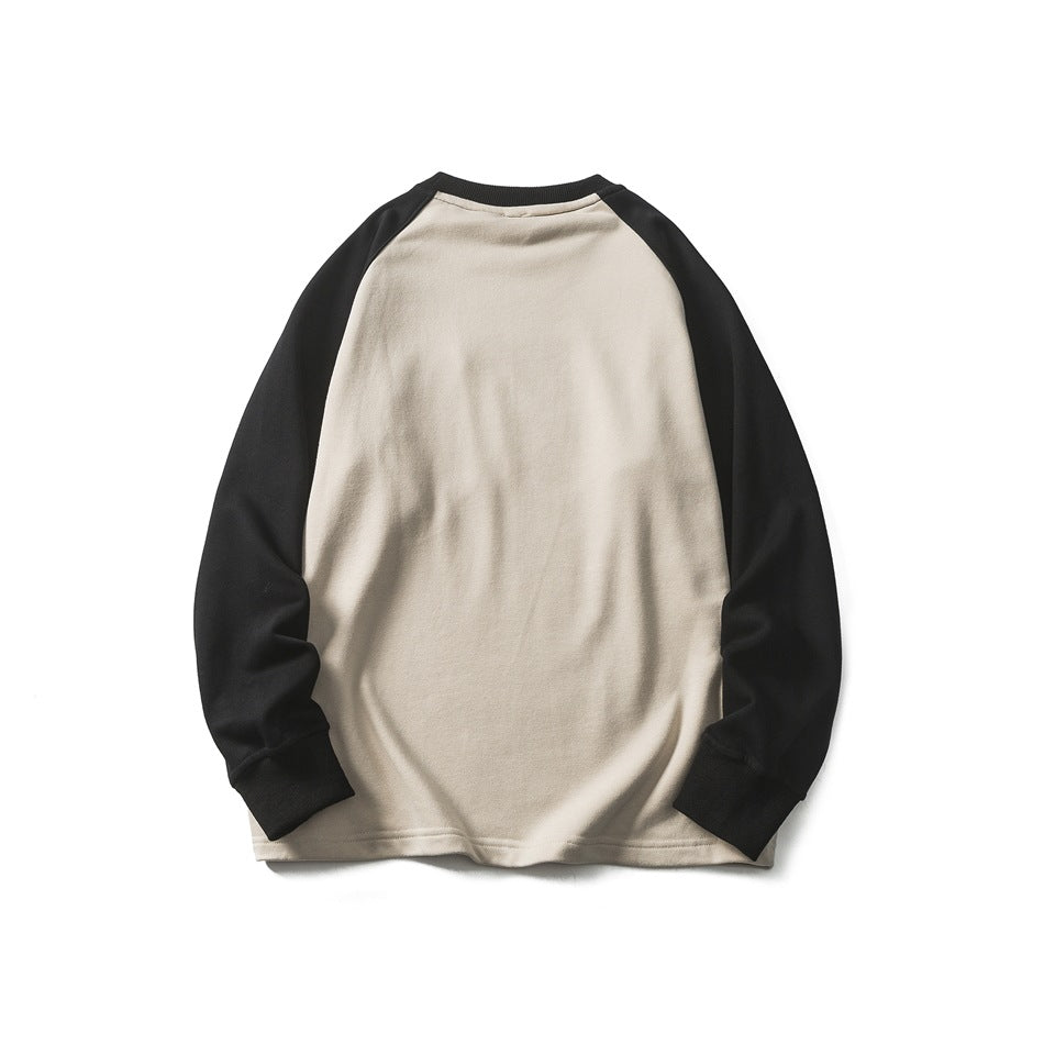 Back view of a cream sweatshirt with black raglan sleeves, ribbed cuffs and collar, shown flat against a white background.