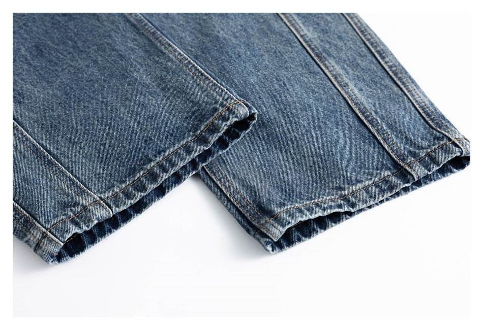 Close-up of two blue denim jean hems with visible double stitching.