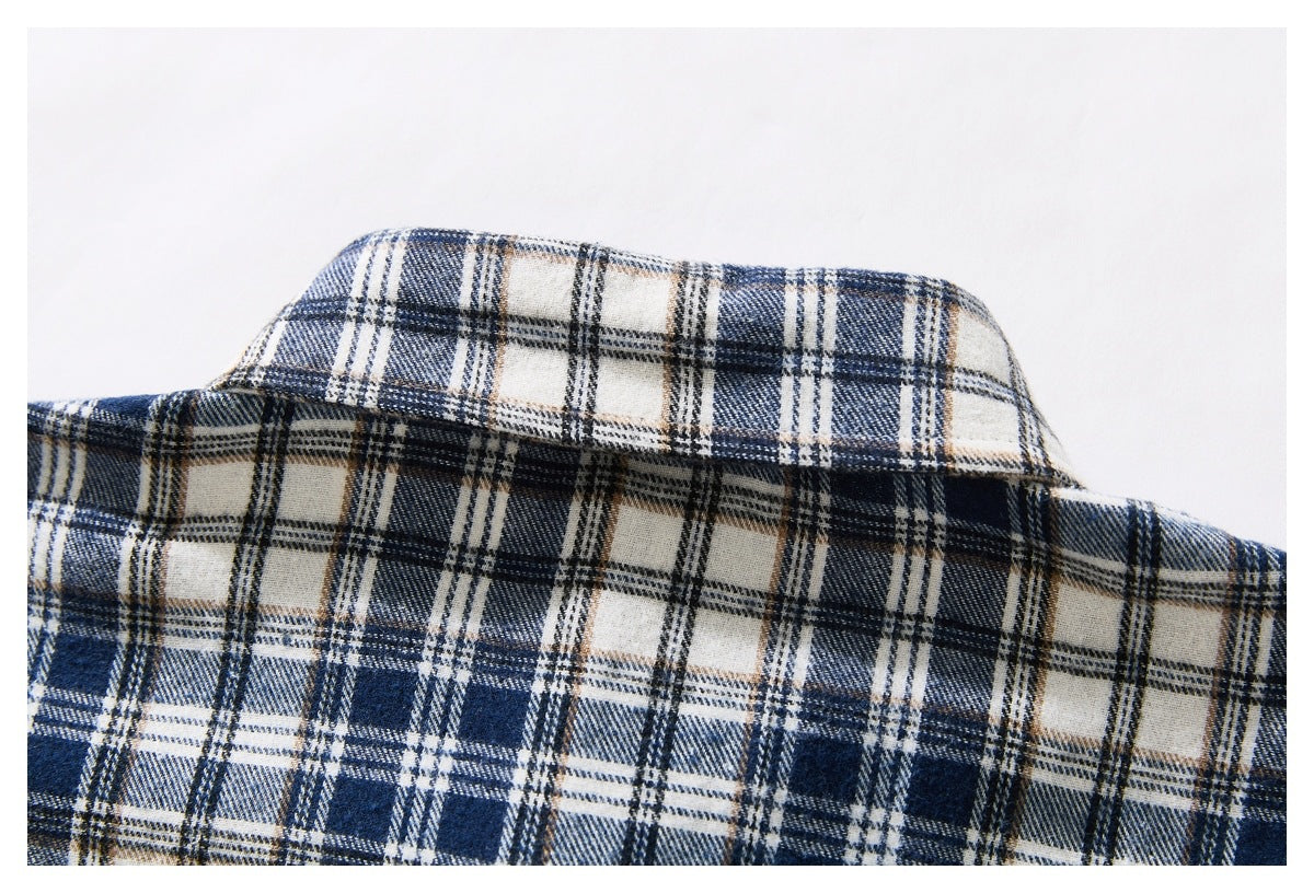 Close-up of the collar and upper back of a navy, cream, gray, and tan plaid shirt.