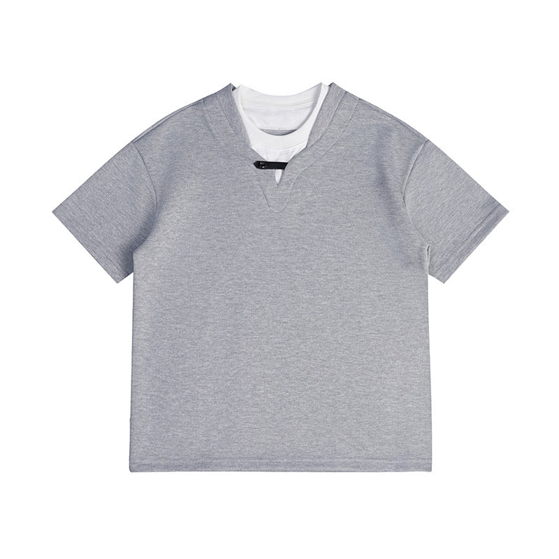Gray short-sleeve faux two-piece T-shirt with white under-layer at the neckline and black tab closure, flat lay
