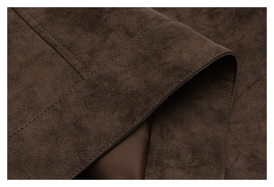 Close-up of a curved edge and stitching on a dark brown garment, showing the lining beneath.