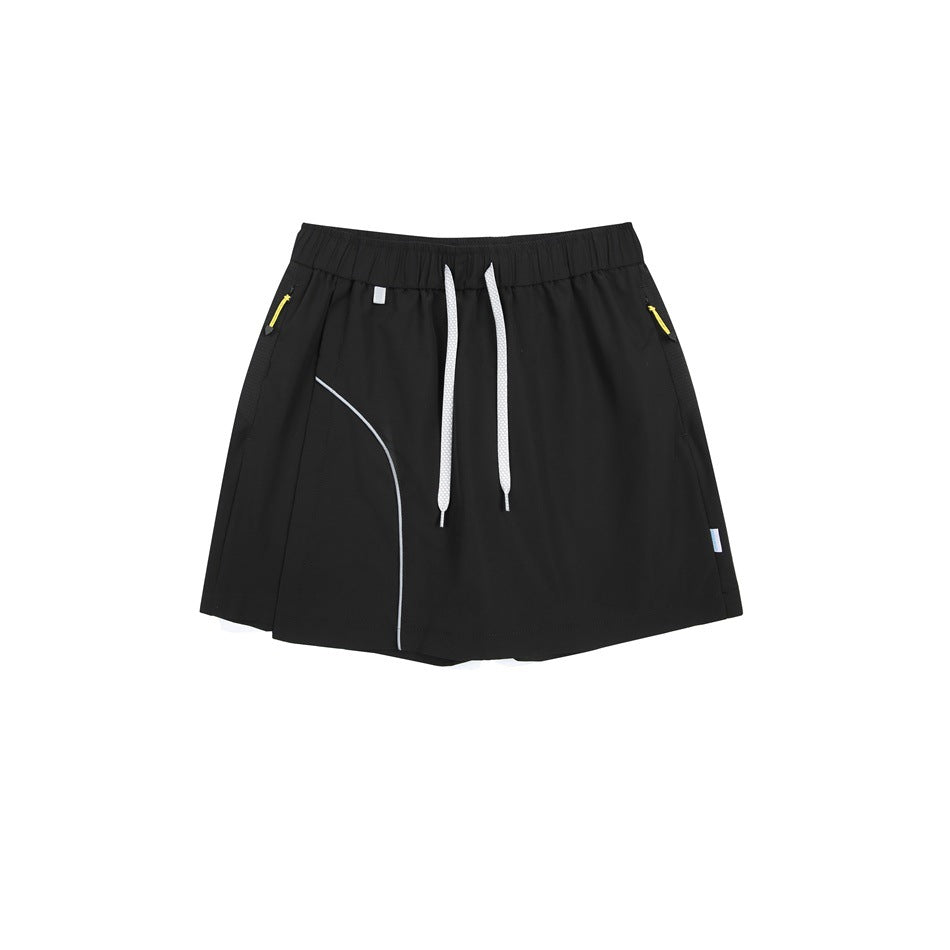 Black skort flat lay with white drawstring, curved light-gray piping and yellow zipper pulls at the side pockets