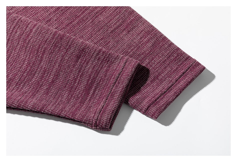 Close-up of the burgundy shirt's long sleeve and stitched cuff.