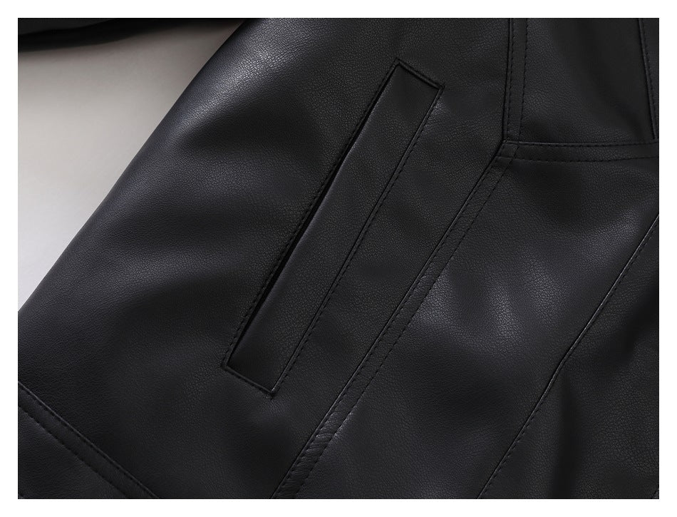 Close-up of a black jacket pocket opening and surrounding stitched panels.