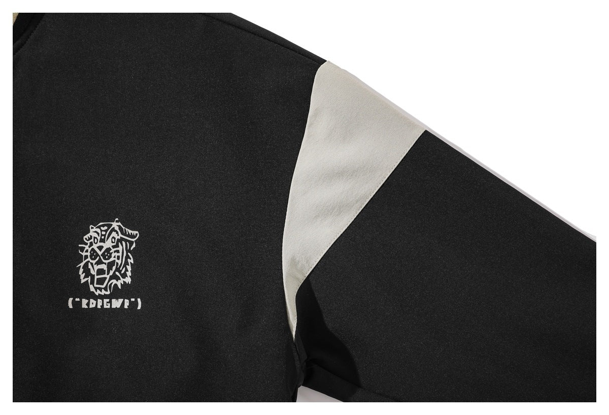 Close-up of the black jacket's cream sleeve insert and white animal-head chest graphic.