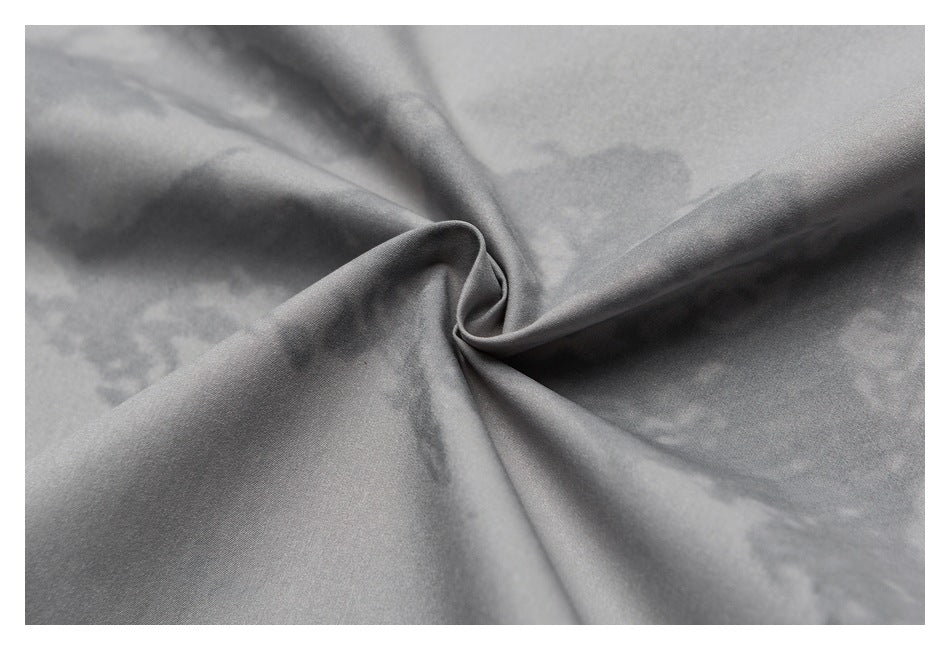 Close-up of gray fabric gathered into a twist, showing its smooth surface.