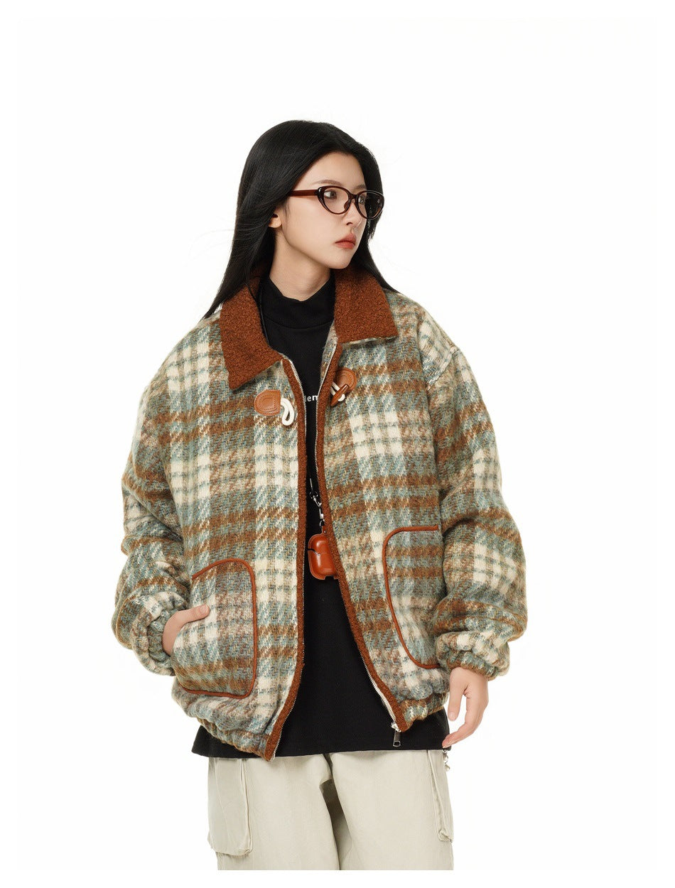 Three-quarter view of a model wearing an open cream, teal, and rust plaid jacket with a rust collar and large pockets.