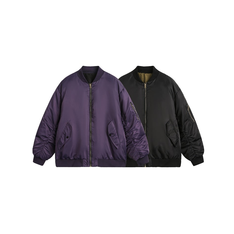 Purple bomber jacket beside a black bomber jacket with olive interior, both with front zippers and ruched sleeves