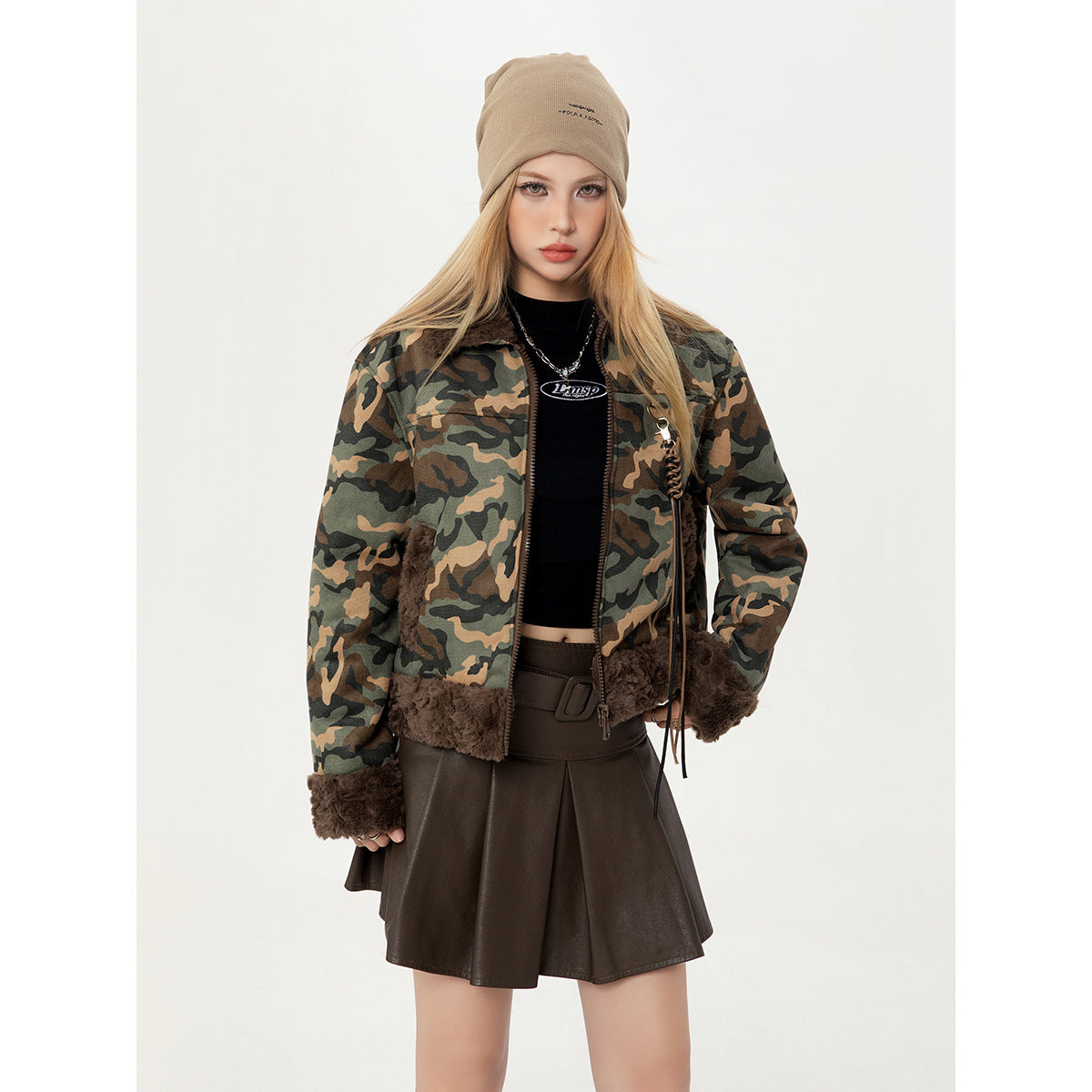 Model in a front view of a camouflage jacket with dark brown plush trim and a front zipper.