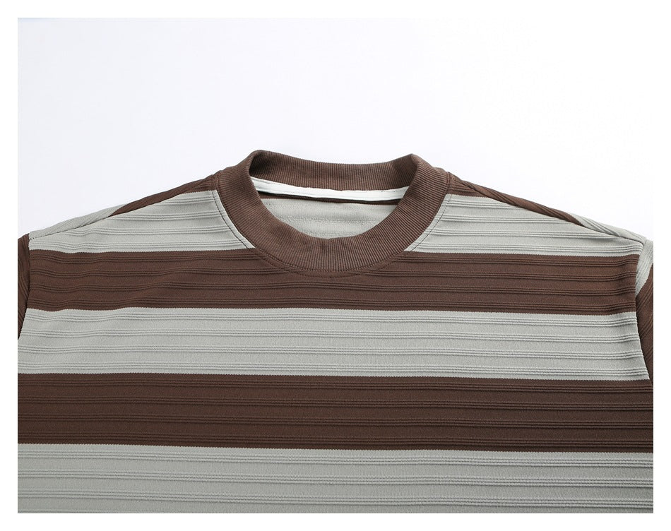 Close-up of a brown and light gray horizontally striped crew-neck short-sleeve shirt, showing the front neckline and chest.
