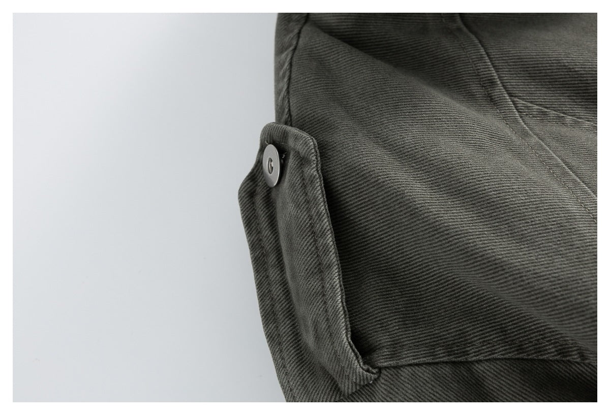 Close-up of a snap-fastened tab and stitched panel on the charcoal gray jacket.