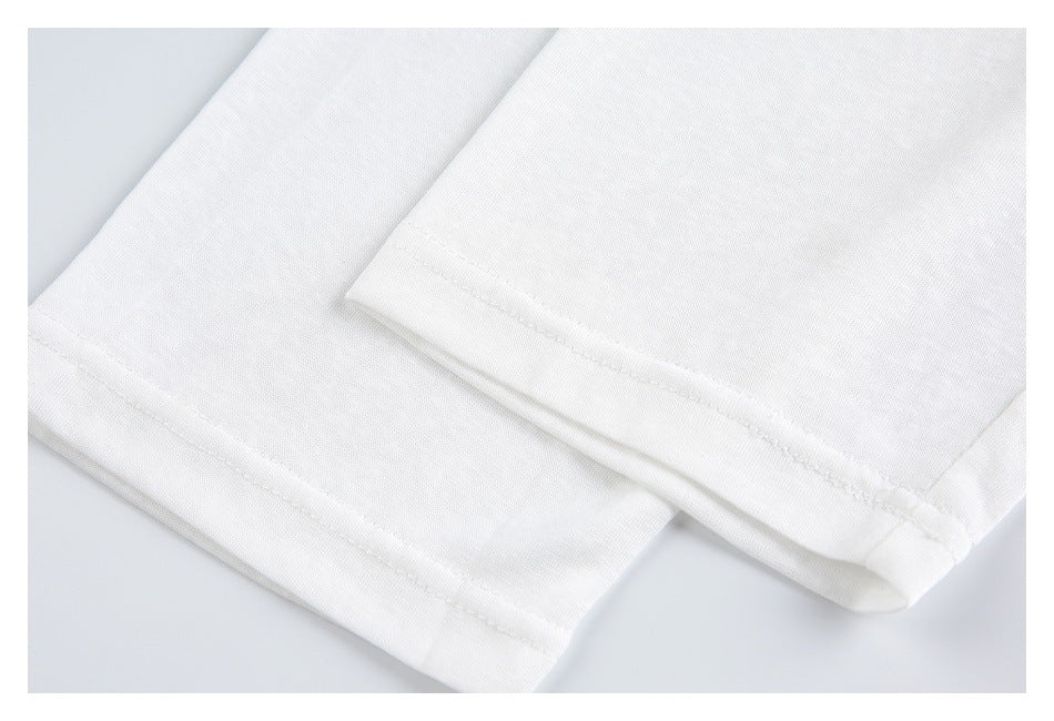 Close-up of two folded hems on a white garment, with neat parallel stitching.