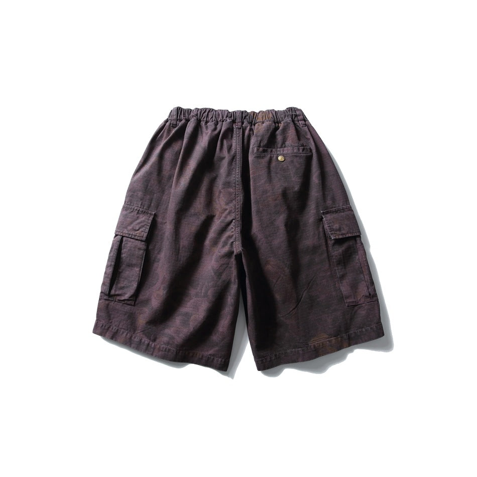 Back view of dark plum cargo shorts with an elastic waist, buttoned rear pocket, and cargo pockets on both legs.
