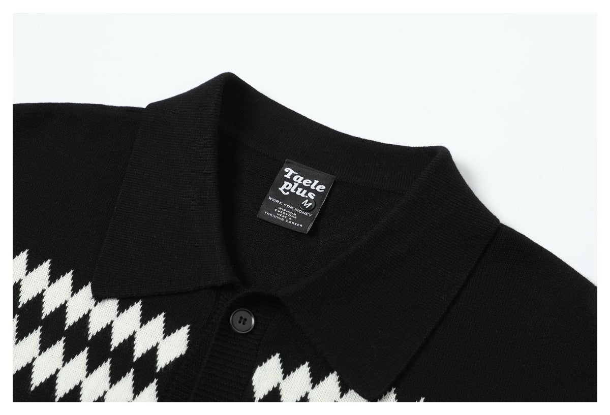 Close-up of a black knit shirt collar, button, and white geometric pattern with a sewn-in neck label.