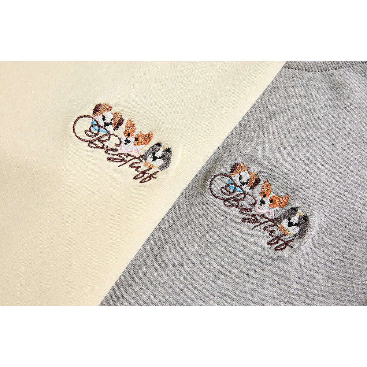 Close-up of embroidered animal artwork on pale yellow and heather gray T-shirt fabric.