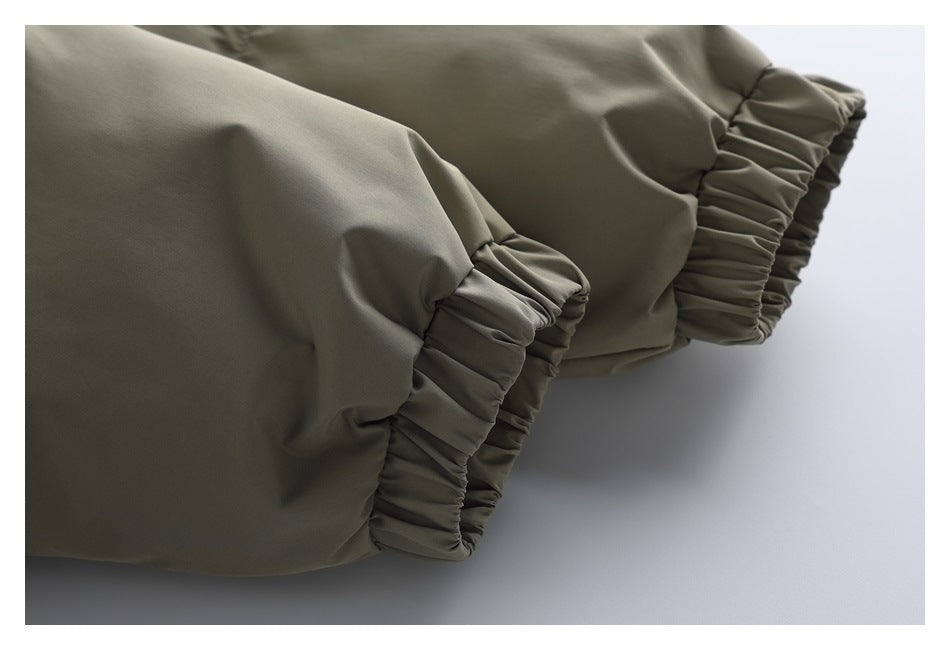 Close-up of the olive-khaki puffer jacket's sleeves, showing gathered elastic cuffs.