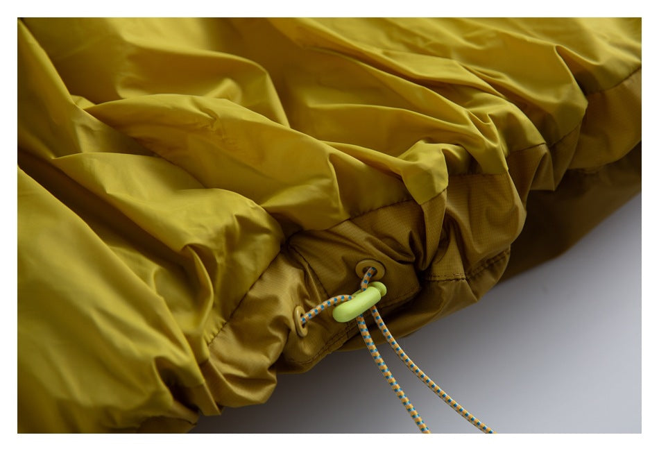 Close-up of the mustard-yellow jacket hem with an adjustable drawcord and toggle.