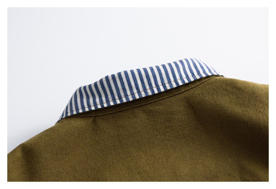 Close-up of an olive-brown jacket collar with blue-and-white striped lining.
