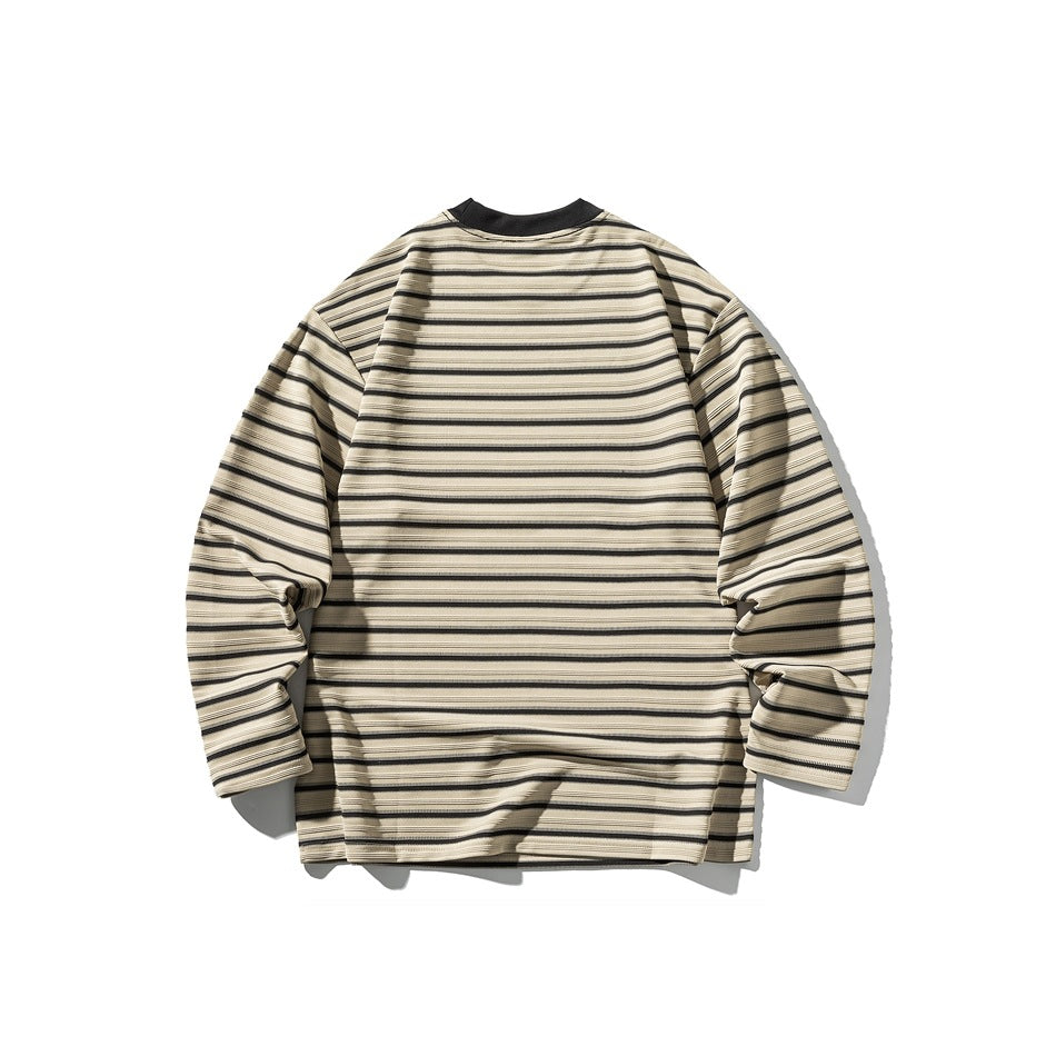 Back view of a beige long-sleeve shirt with narrow black horizontal stripes and a black crew neck, on white.