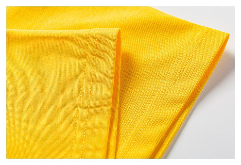 Close-up of bright yellow fabric with a neatly stitched folded edge.