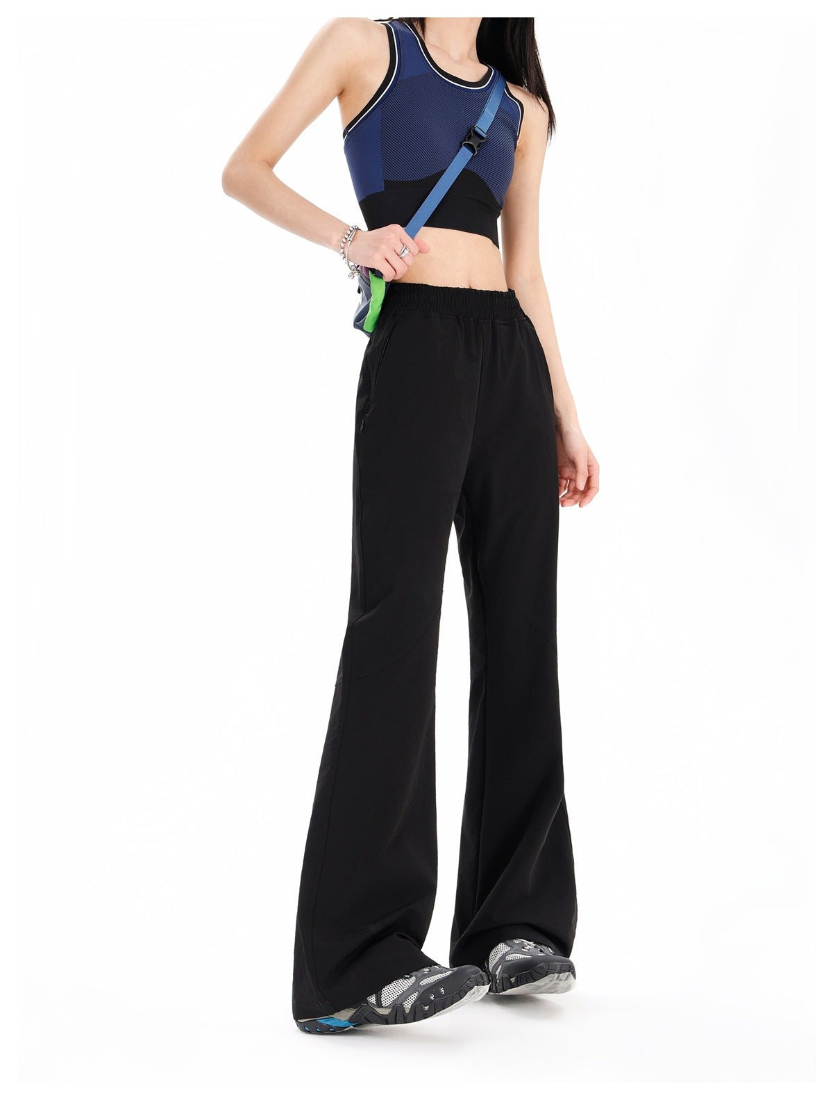 Model wearing black wide-leg pants with an elastic waist and curved seam panels.